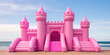 Big Inflatable Pink bounce castle on a sandy beach against blue sky, minimal style summer wallpaper, nobody. Sea beach vacation, fun activity for kids.