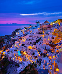 Oia village, windmills, Santorini island, Greece at colorful sunset