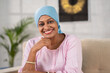 Happy smiling recovered indian woman cancer patient confidently looking at camera at home - concept of Cancer Survivor, Positive Attitude and inspirational