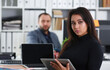 © H_Ko - young pretty brunette woman in office work with her boss hold tablet in hands
