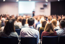 Business People Or Students Are Watching A Presentation Or Attend A Training Or Seminar In A Lecture Hall Or Auditorium. Conference Hall Full Of People Participating In The Business Training