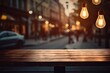 The blurry shop window of a cafe is adorned with a wooden table top and a light bulb. It serves as the perfect background for creating a montage of product displays or a key visual design.