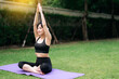 © Jirawatfoto - Fitness Fusion. Asian young woman 30s wearing sportswear stretching muscle in park and practices yoga amidst lush surroundings, achieving physical and mental harmony for a refreshed spirit.
