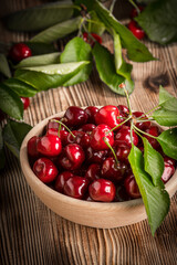 Wall Mural - Sweet cherries in a wooden bowl.