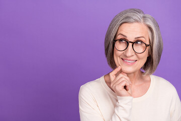 Sticker - Photo of funny pensioner lady interested look empty space tricky face bite lower lip sly clever idea isolated purple color background