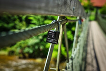 Padlock As A Symbol Of A Couple's Love Hanging From A Bridge