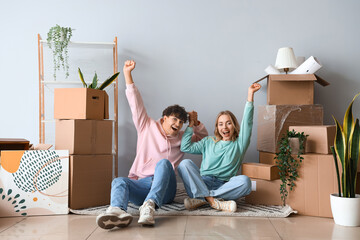 Poster - Happy young couple sitting in room on moving day