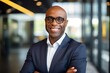 © NikoG - Portrait of a middle aged african american businessman looking at the camera in an office