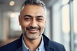 © CojanAI - Middle aged businessman of arab ethnicity smiling in a modern office and looking at camera