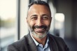 © CojanAI - Middle aged businessman of arab ethnicity smiling in a modern office and looking at camera