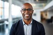 © CojanAI - Portrait of a middle aged african american businessman looking at the camera in an office
