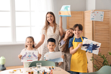 Sticker - Little pupils with drawings and teacher in art class