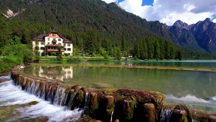 Wall Mural - Most beautiful and scenic lakes of northern Italy. Lago di Dobbiaco in Val Pusteria, South Tyrol. Trentino-Alto Adige. aerual drone overflight video in 4K