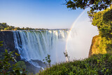 Fototapeta  - Scenic view of Victoria Falls with rainbow on the border between Zambia and Zimbabwe