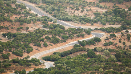 Wall Mural - Asphalt country road and rural landscape view from Tepeköy (Agridia) village in Gökçeada (Imbros) Turkey on a sunny summer day. Canakkale, Turkey. Aerial view