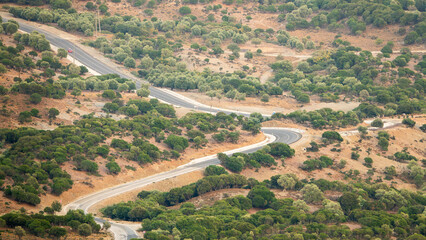 Wall Mural - Asphalt country road and rural landscape view from Tepeköy (Agridia) village in Gökçeada (Imbros) Turkey on a sunny summer day. Canakkale, Turkey. Aerial view