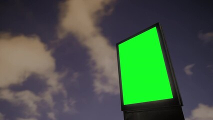 Wall Mural - timelapse: blank vertical street green billboard poster or advertising pillar against the dark sky w