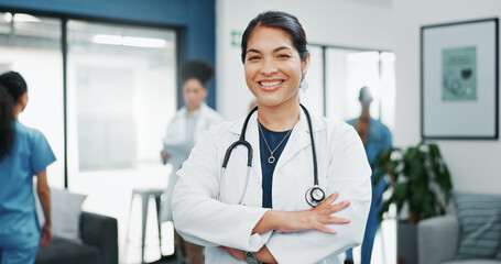 Canvas Print - Face, doctor and arms crossed in busy hospital for about us, medical life insurance or wellness support. Smile, happy and healthcare woman in portrait, confidence trust or clinic medicine leadership