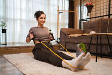 One Woman Beautiful Caucasian Female Training At Home In Room Using Rubber Resistance Bands Tubes Sportswoman Doing Exercises Alone Health And Fitness Concept Copy Space