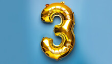 Banner With Number 3 Golden Balloon With Copy Space. Three Years Anniversary Celebration Concept On A Blue Background.