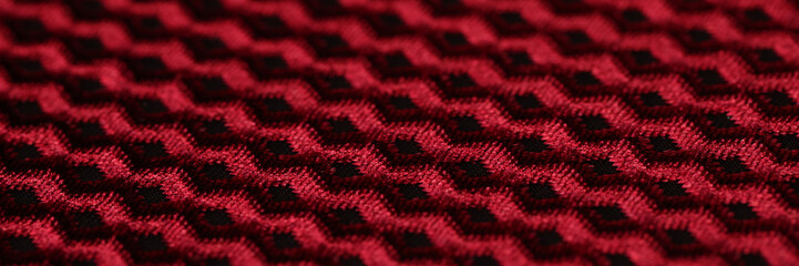 Sticker - Red and black fabric with geometric pattern.