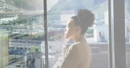 Canvas Print - Animation of biracial businesswoman in office over people walking and cityscape