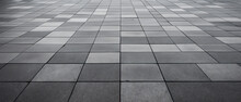 Rows And Lines Of Square Sidewalk Tiles In A Gray Color