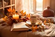 © irissca - Autumn cozy mood. Fall cozy reading nook with a blanket, bookshelf filled with autumn-themed books, and a cup of tea or hot chocolate.