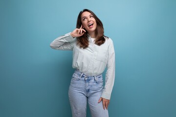 Poster - bright optimistic happy 25s woman with black hair in casual clothes on studio background with copy space