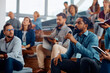 © Drazen - Black entrepreneur asking question while attending business seminar in conference hall.