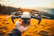 © VisualProduction - Hand holding drone. Hand guiding compact drone flight.