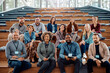 © Drazen - Multiracial group of happy business seminar attendees at convention center looking at camera.