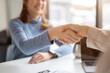 © bongkarn - A beautiful Asian female client shakes hands with a businesswoman after the meeting.