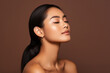 © wolfhound911 - Beautiful sensual sexy young Asian ethnic woman model posing profile side face touching chin on brown background