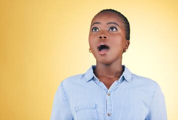 Surprise, wow or face of black woman in studio on yellow background amazed by retail discount deal. Wtf, omg or mind blown person shocked by sale offer, promotion or news announcement with mouth open