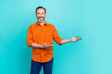 Wall Mural - Photo of confident optimistic businessman entrepreneur pensioner hands hold product empty space isolated on aquamarine color background