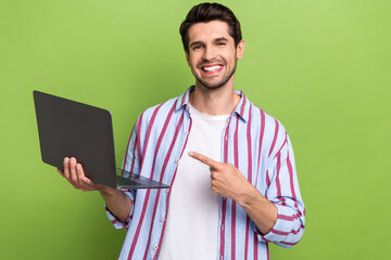 Aufkleber - Portrait of young positive man indicate finger empty space laptop high efficiency new technologies isolated on green color background