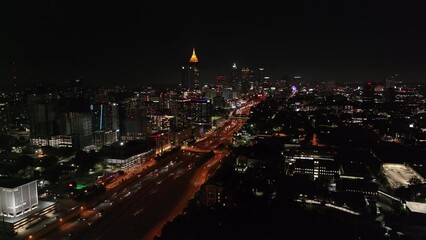 Wall Mural - Atlanta buildings downtown at night along with cars traveling down the interstate