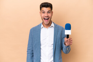 Wall Mural - Young caucasian TV presenter man isolated on white background with surprise facial expression