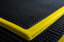 Macro Shot Of A Safety Mat With A Bright Yellow Border For High Visibility And Safety In Industrial Settings
