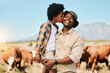 Farm, cows and child kiss father in countryside for ecology, adventure and agriculture. Family, sustainable farming and African dad happy with boy embrace for bonding, relax and learning with animals