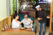 © PRASANNAPIX - Customer showing thumps up for thanking after Waiter serv food at restaurant