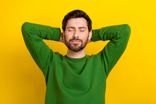 Portrait Of Young Chilling Peaceful Man Wear Green Pullover Hands Head Take Nap Slumber Relaxation Isolated On Yellow Color Background