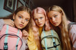 © Uncanny Valley - Young, modern teenage girls, a group of friends with backpacks full of books ready to go back to school. Autumn has arrived, classrooms are filled with students.
