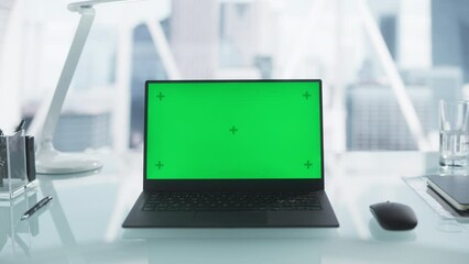 Laptop Computer with Mock Up Green Screen with Chromakey Display with Motion Trackers Standing on a Modern Office Desk. Table Space with a Mouse, Notebook, Black Pens. Static Footage