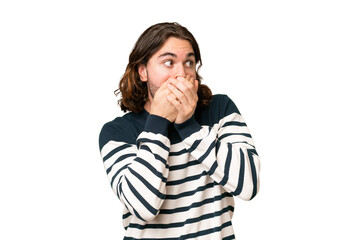 Wall Mural - Young handsome man over isolated background covering mouth and looking to the side