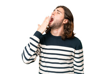 Wall Mural - Young handsome man over isolated background yawning and covering wide open mouth with hand