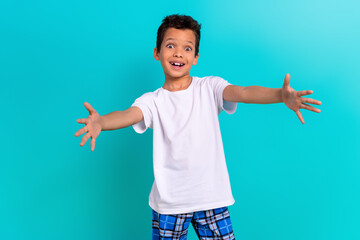 Photo of excited cheerful boy wear trendy white clothes open arms hug you isolated on cyan color background