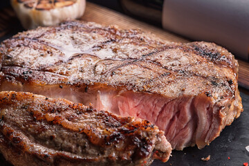 Wall Mural - Meat steak medium, on a board with a stone and a bottle of wine