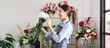 © Katcha - Female florist in apron holding white chrysanthemum with enjoying to creating and designing floral for
